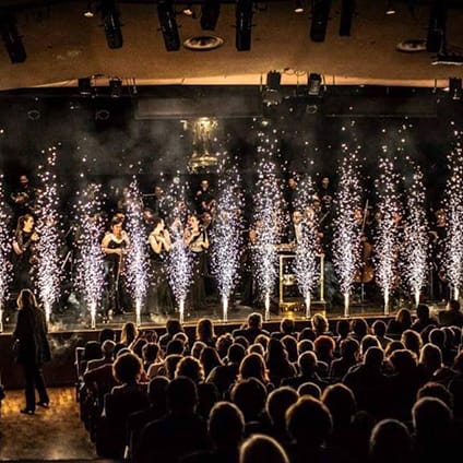 Escenario con violinistas para eventos con luces y fuegos festivos